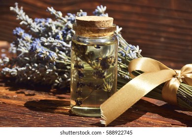 Lavander Oil With Flower On Wooden Background