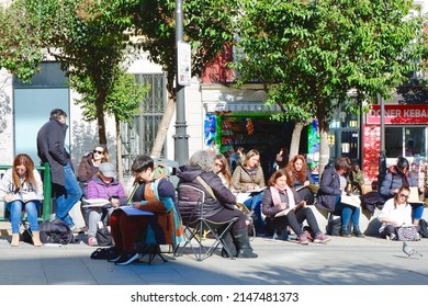 Lavapies District, Madrid, Spain - April 2, 2022: Group Of People Of Different Ages Painting Together Outside In The Local Park. Open Air Hobby Activities.