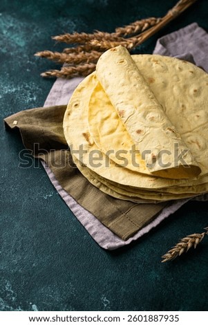 Lavash flat bread on green background