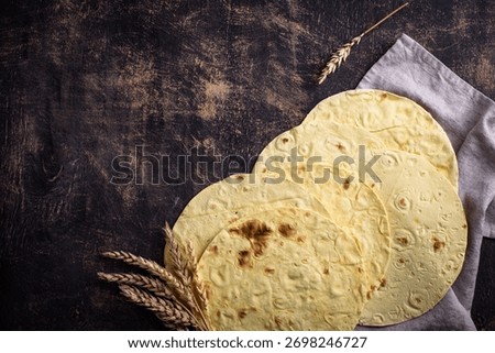 Lavash flat bread on green background