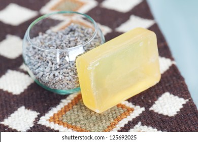 lavender in bowl and soap on ethnic mat - Shutterstock ID 125692025