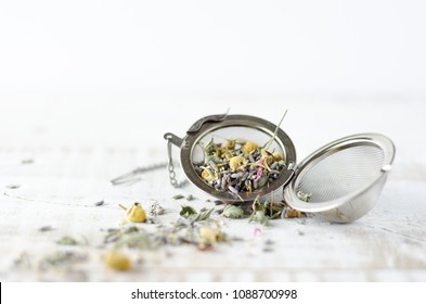 Lavender and Chamomile loose tea herbs on white wash wooden background