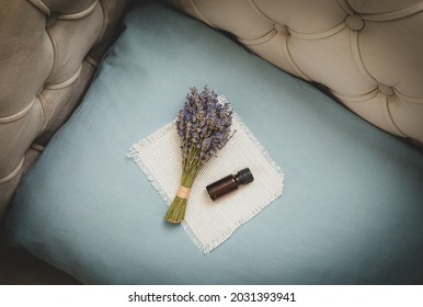 Lavender Flower Essential Oil For Better Good Night Sleep. Lavender Oil And Bouquet Of Dried Lavender Flowers On Soft Pillow In Home Bedroom. Aromatherapy Concept.