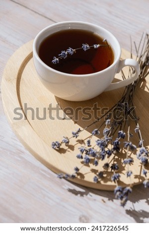 Lavender flowers with herbal cup of tea. Concept of Herbal medicine natural remedy. Organic relieving stress. Healthy beverage fresh delicious floral hot tea. Antispasmodic effect naturopathy