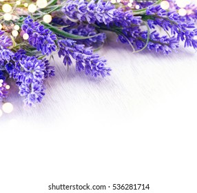 Lavender Flowers Over White Wooden Table. Aroma Lavender Flowers Border Design. Aroma Treatment Concept.