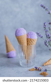 Lavender honey ice cream in the horn in a glass with lavender flowers. Summer seasonal cold sweet healthy vegan dessert. High quality photo
