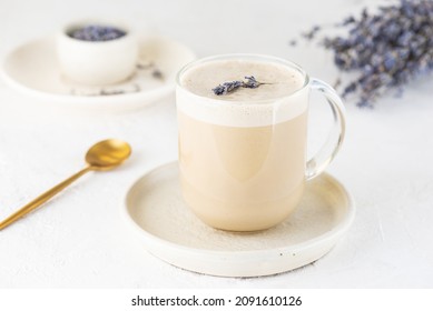 Lavender Latte Coffee With Coconut Milk In A Glass Mug On A Light Table.