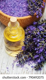 Lavender and massage oil on a old wooden background