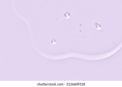 Lavender oil texture. Lquid puddle with bubbles on violet color background. Essential oil, serum, cosmetic product macro