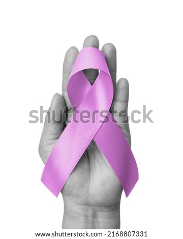 Lavender ribbon awareness for National cancer survivors month in June with lavender purple bow color isolated on hand on white background with clipping path