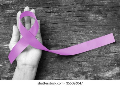Lavender Ribbon for cancer awareness (all kinds) color splashed on human hand aged wood  - Shutterstock ID 355026047