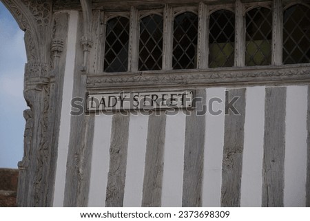 Lavenham, UK - September 16 2023: Lady Street and Unsuitable for heavy vehicles information boards. Wall of traditional Tudor era timber framed cottage. Visible typical oak beams of the construction.