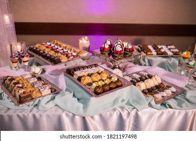 Lavish Dessert Table With Assorted Pastries, Cakes, Confections, Fruit, And Treats Laid Out On A Buffet For A Fancy Catered Event Reception