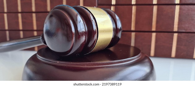 Law Book With Judges Wooden Gavel In Courtroom Or Law Enforcement Office. Judgment And Sentence Verdict Concept