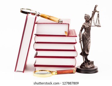 law book, magnifying glass and scales of justice