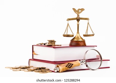 law books, money , magnifying glass and scales of justice