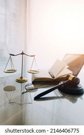 Law Books And Scales Of Justice On Desk In Library Of Law Firm. Jurisprudence Legal Education Concept.