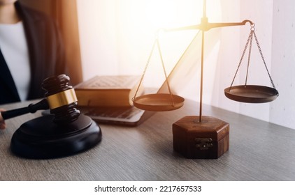 Law Books And Scales Of Justice On Desk In Library Of Law Firm. Jurisprudence Legal Education Concept.