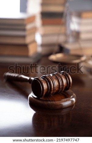 Law code concept. Mallet of the judge on wooden table.