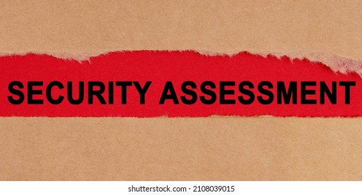 Law Concept. Among The Torn Sheets Of Paper On A Red Background, The Inscription - Security Assessment