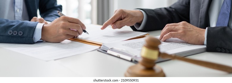 law concept The entrepreneur who wears the black suit trying to ask the lawyer to clarify the legislation that seems to confuse him. - Shutterstock ID 2109550931