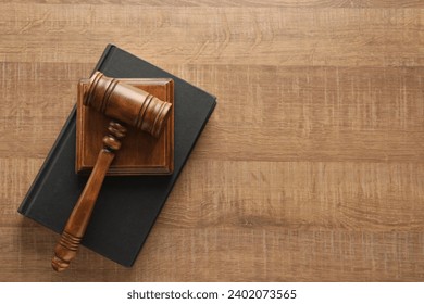 Law concept. Gavel and book on wooden table, top view. Space for text - Powered by Shutterstock