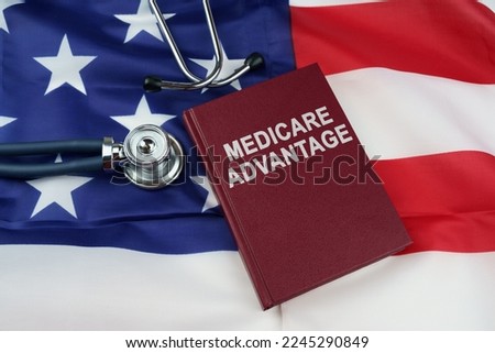 Law concept. On the US flag lies a stethoscope and a book with the inscription - Medicare Advantage