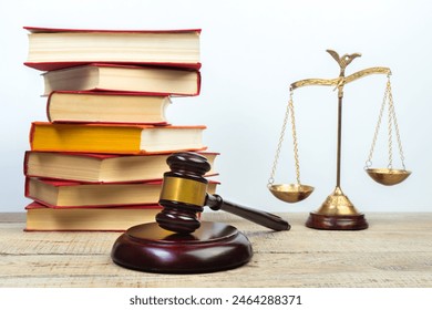 Law concept - Open law book, Judge's gavel, scales, Themis statue on table in a courtroom or law enforcement office. Wooden table, white background. - Powered by Shutterstock