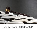 Law concept - Open law book with a wooden judges gavel on table in a courtroom or law enforcement office on blue background. Copy space for text