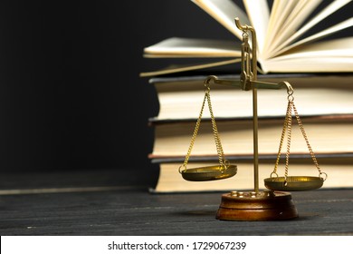 Law concept - Open law book with a wooden judges gavel on table in a courtroom or law enforcement office isolated on white background. Copy space for text