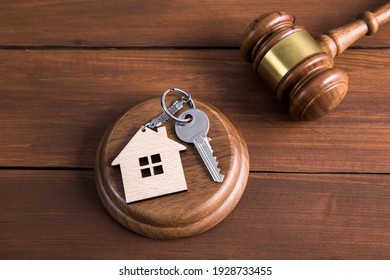 Law Concept, Wooden Judge And House Model With Key
