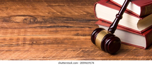 Law concept - Wooden judges gavel and book on table in a courtroom or law enforcement office. Copy space for text. - Shutterstock ID 2059619174