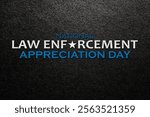 Law enforcement appreciation day is observed every year on January 9. Inscription on black textured background with with transparent American flag.