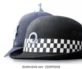 Law Enforcement Careers Concept. Headwear Of UK Police Patrol Officers- Female Chief Constable Patrol Hat In Front Of Male Mobilefoot Patrol SergeantConstable Custodian Helmet As Worn At Incidents.