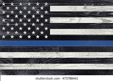 A law enforcement police support flag painted on white washed wood grained boards.