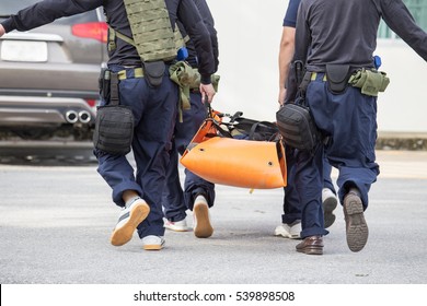 Law Enforcement Team Use Light Stretcher For Medical Evacuation To Vehicle In Training Course