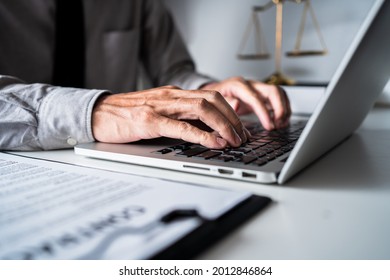 Law Firm Office, Close-up View Of Businessman Or Lawyer Using A Laptop With Contract Paper, Working Online On A Computer At Home, Typing On A Keyboard, Searching Information On Web Browser.