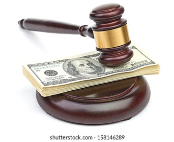 Law gavel on a stack of American money.