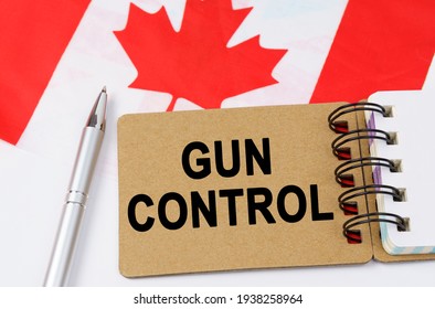 Law And Justice Concept. Against The Background Of The Flag Of Canada Lies A Notebook With The Inscription - GUN CONTROL