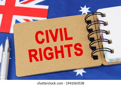 Law And Justice Concept. Against The Background Of The Flag Of Australia Lies A Notebook With The Inscription - CIVIL RIGHTS