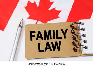 Law And Justice Concept. Against The Background Of The Flag Of Canada Lies A Notebook With The Inscription - FAMILY LAW