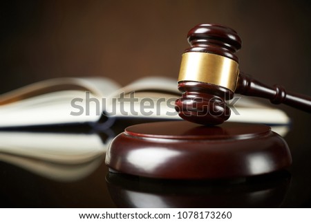 Law and Justice concept Judge hammer and book with reflection
