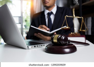 Law And Justice Concept. Lawyer Working With Laptop Report The Case On Table In Modern Office.