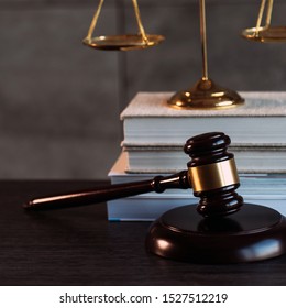Law and Justice, judge gavel with scales on wooden table with blurred background.