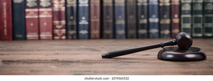 Law and Justice, Legality concept, Judge Gavel on a wooden background, Law library concept. - Shutterstock ID 1074565532
