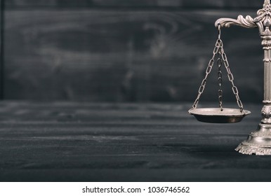Law and Justice, Legality concept, Scales of Justice on a black wooden background.