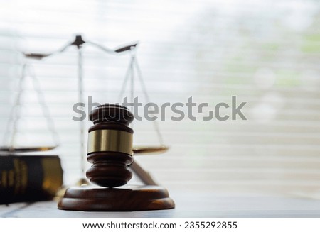 law and justice is represented by a mallet gavel of the judge, scales of justice, and books