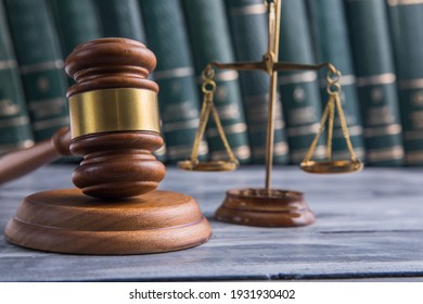 Law and Justice Symbols with law books on background. Law concept image.