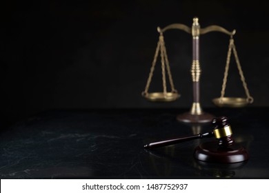 Law and justice symbols on dark background.