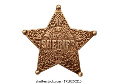 Law And Justice In The Wild West, American Western Culture And Legal Authority Concept With Picture Of Metal Sheriff Badge Isolated On White Background With Clipping Path Cutout